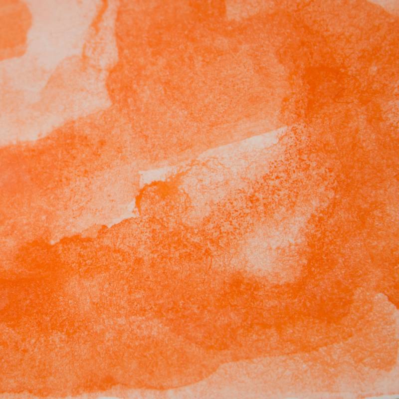 Closeup of dark orange watercolor paint