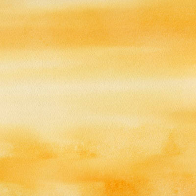 Closeup of dark yellow watercolor paint.