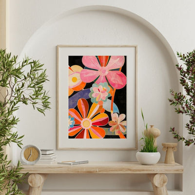 Poster wall art showing 'Blooming Bright – Vivacious Floral Art' on a wall surrounded by plants